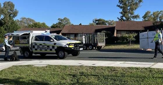 Police at the scene of the crash on Canopus Crescent. Picture by ACT Policing