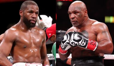 Boxers Floyd Mayweather and Mike Tyson in the ring, both in fighting stance, wearing boxing gloves and shorts.