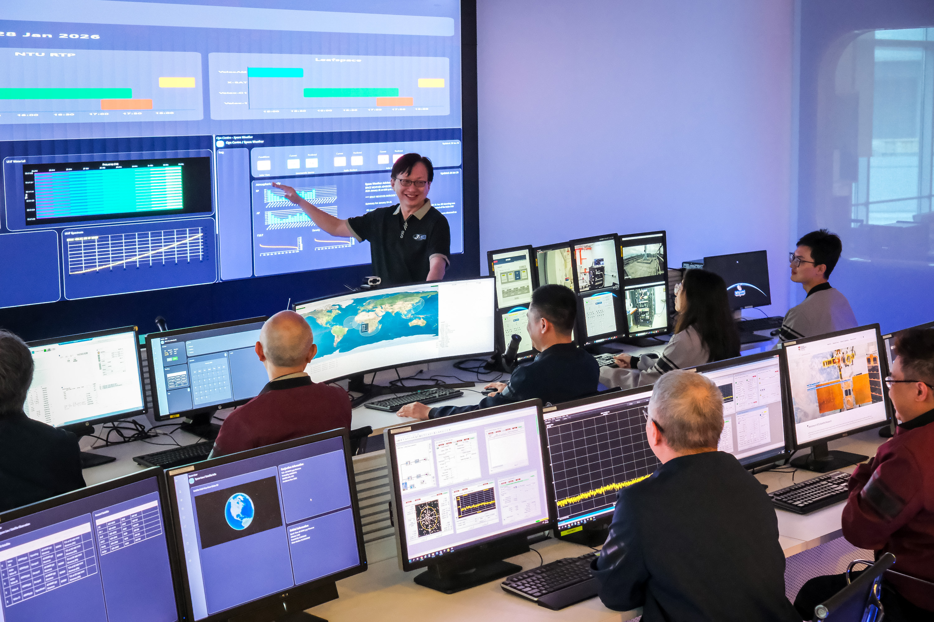 Exec Dir Lim Wee Seng briefing his team at the upgraded mission control at NTU's Satellite Research Centre