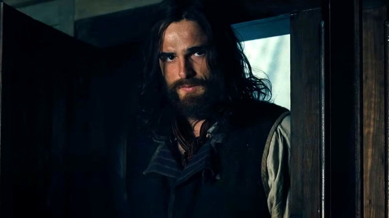 Heathcliff brooding in a doorway in Wuthering Heights