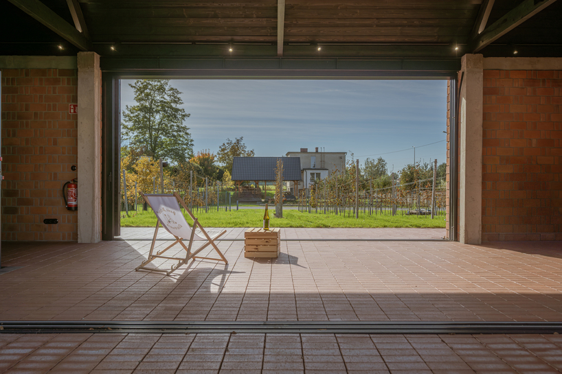 barrel-vaulted concrete cellar organizes vineyard building in poland