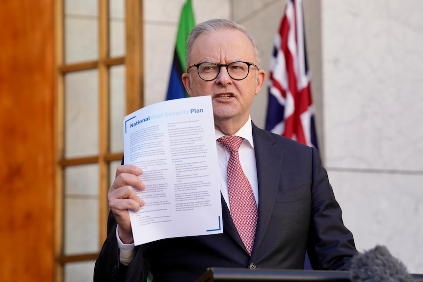 Men in suits speak at a press conference