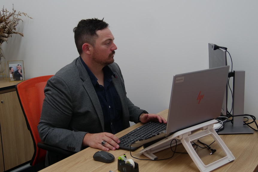 Jacob Cass sits at his desk