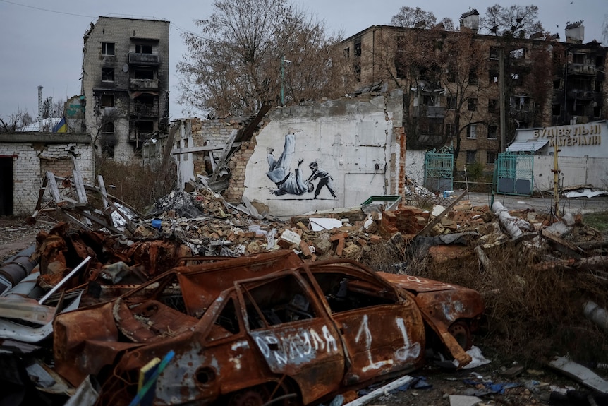 A mural of a young boy flipping over an older man resembling Vladimir Putin. 