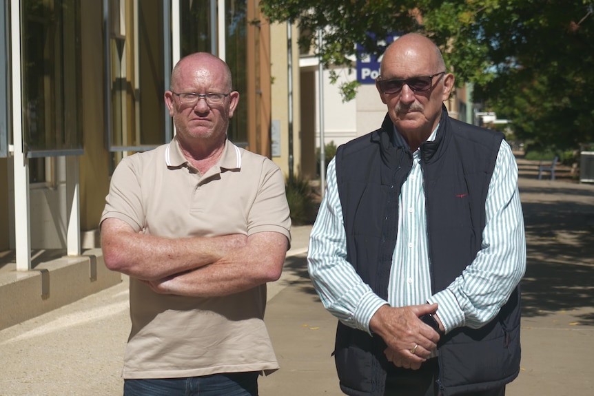 Two men stand cross armed and angry on a Mildura streetside