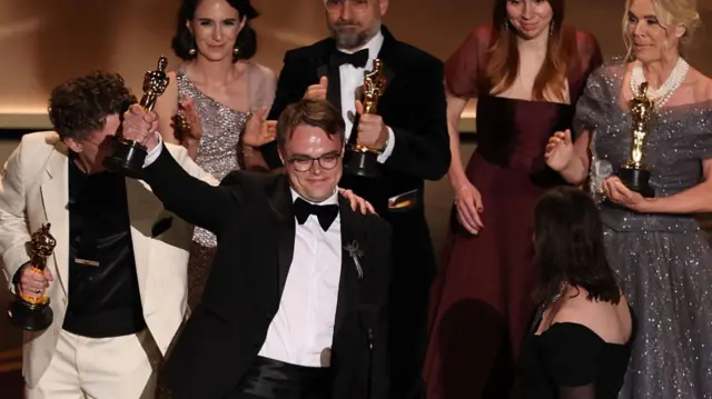 Pavel Talankin holds up his Oscar onstage