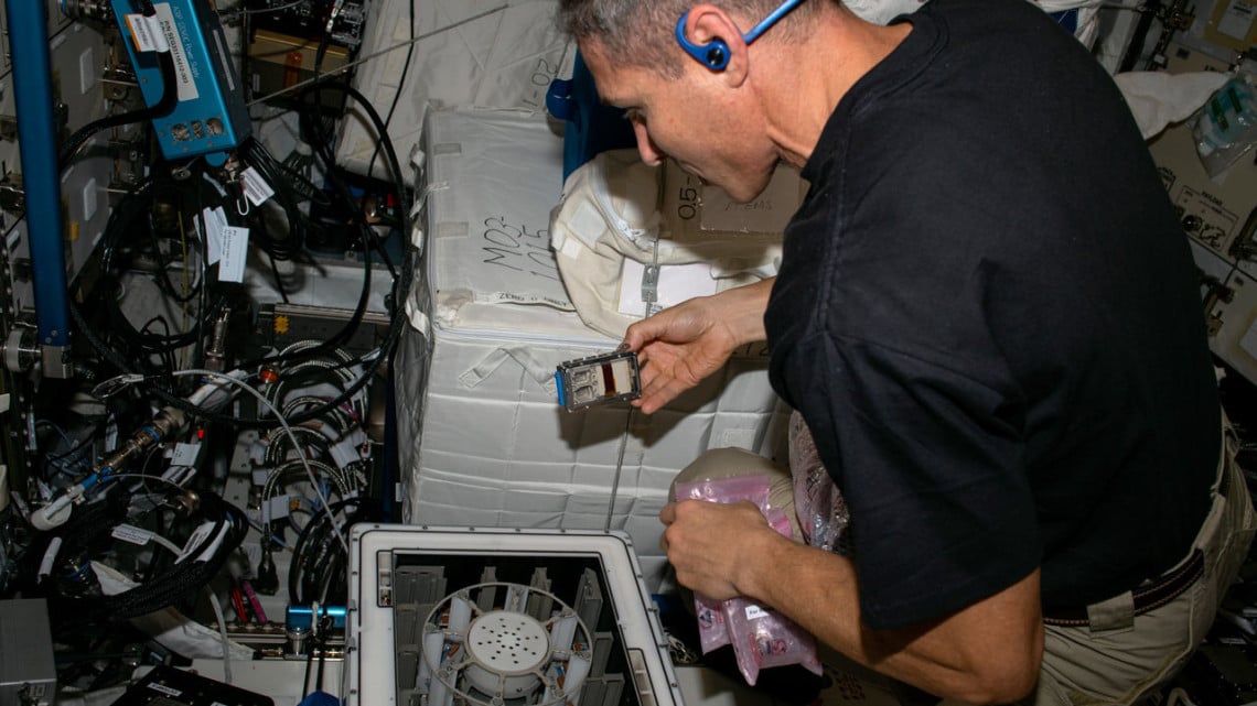 Michael Scott Hopkins performs a microgravity experiment on the International Space Station. Credit: NASA/ESA