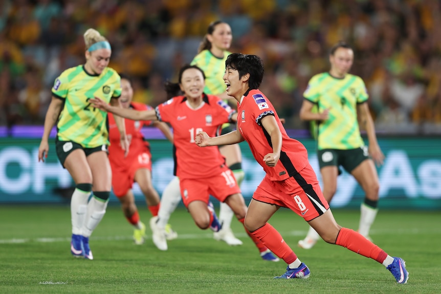 Kim Shinji celebrates after scoring from the penalty spot