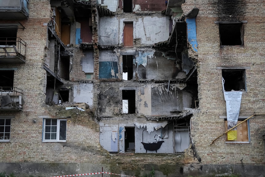 A graffiti in Banksy's signature style was seen on the wall of a destroyed building in the Ukrainian village of Horenka.