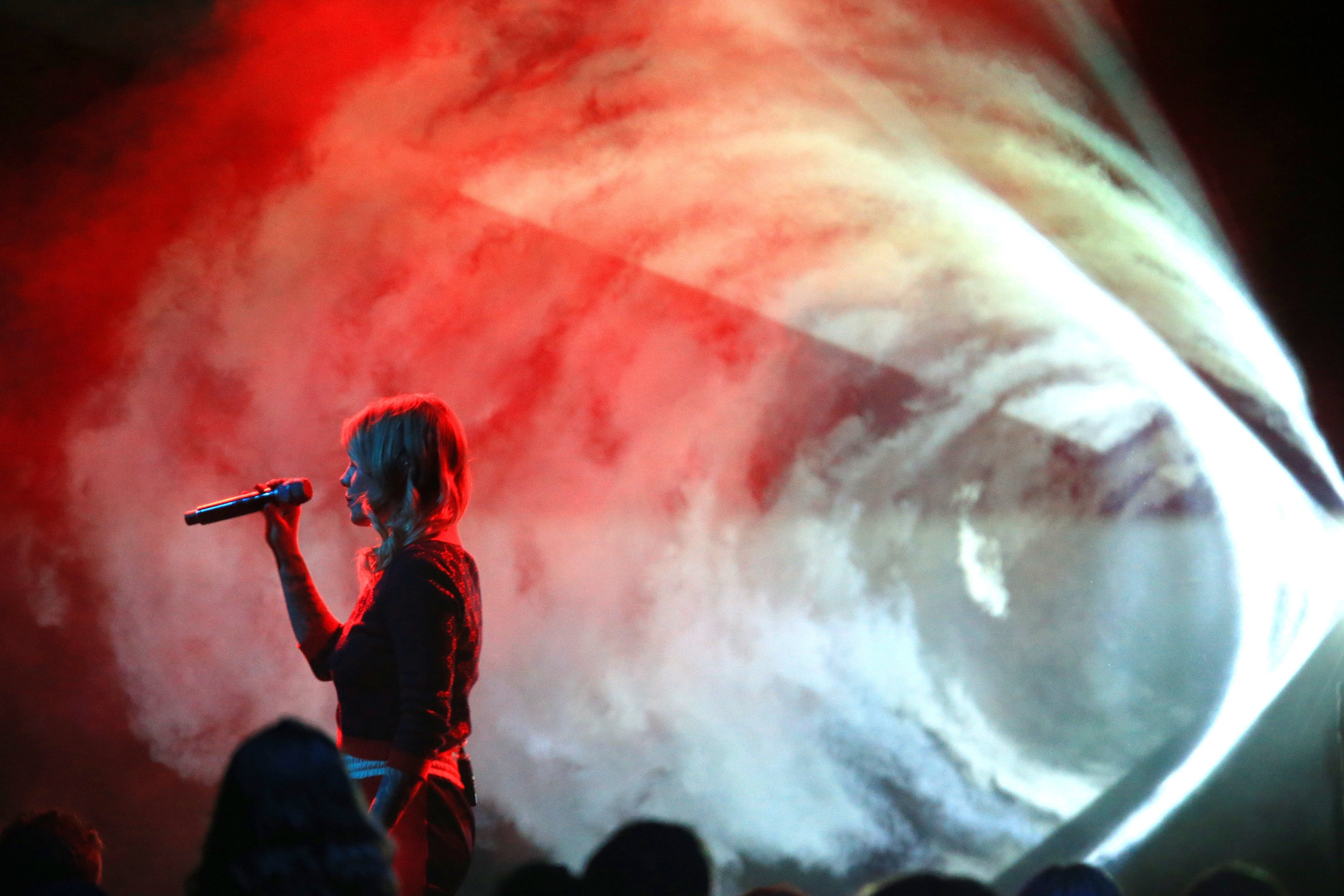 Coeur de Pirate holding a microphone singing on stage at the Junos in 2019.