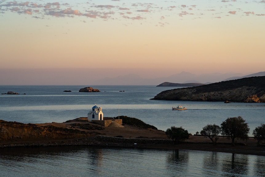 A boat and a lighthouse in Lipsi.