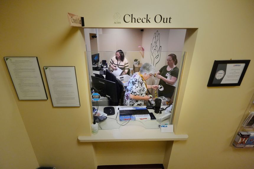 Employees at Ammonoosuc Community Health Services pack up the reception office at the clinic, which closed for good in October.