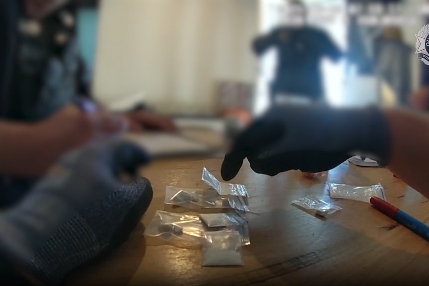 Blurred police footage inside a house.