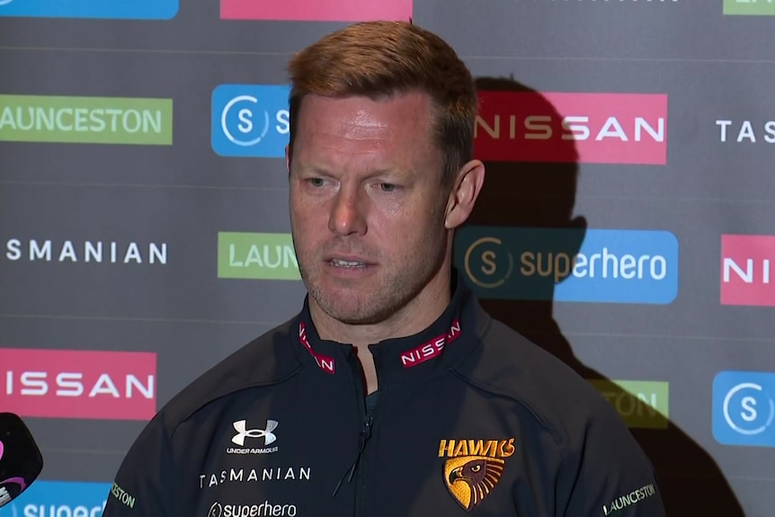 Sam Mitchell speaks to reporters at a press conference.