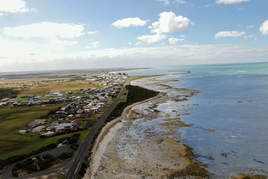 A drone photo of a town on the coastline. 
