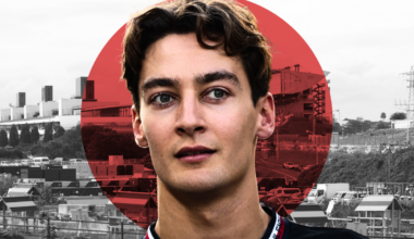 George Russell looks on with the Japan flag in the background