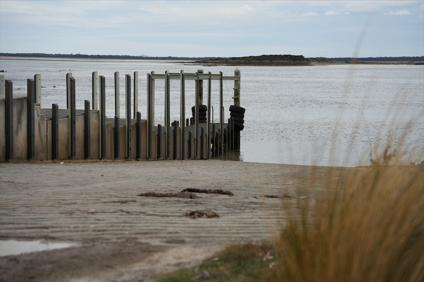 A boat ramp stretching out into the water.
