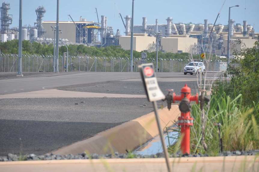 A car drives past the outside of the gas plant