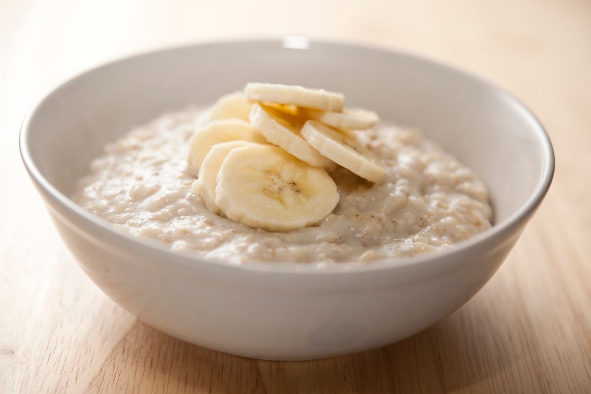 Bowl of porridge with sliced banana