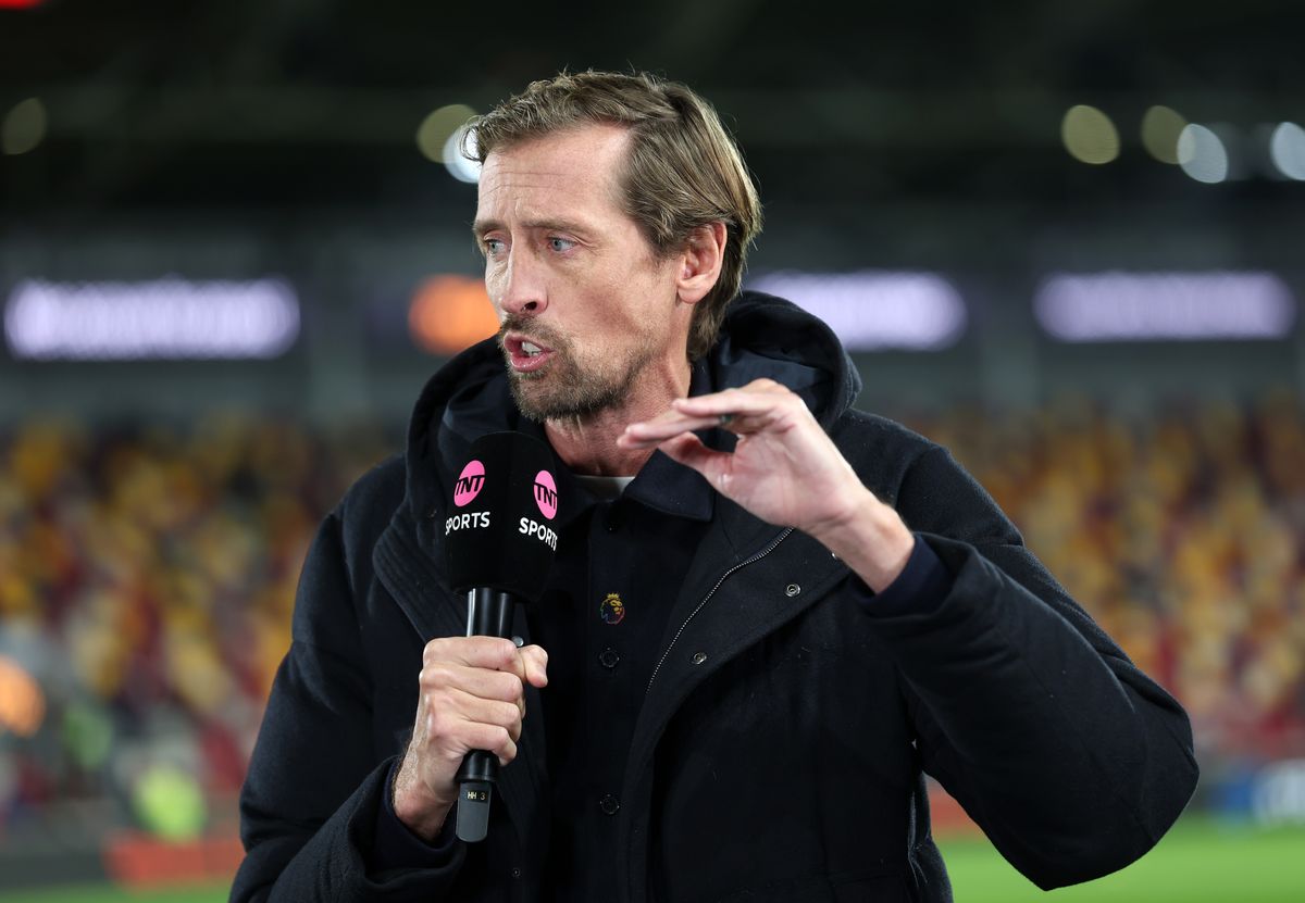 Presenter Peter Crouch wears the Premier League 'With pride' pin badge during the Premier League match between Brentford and Arsenal at Gtech Community Stadium on February 12, 2026 in Brentford, England