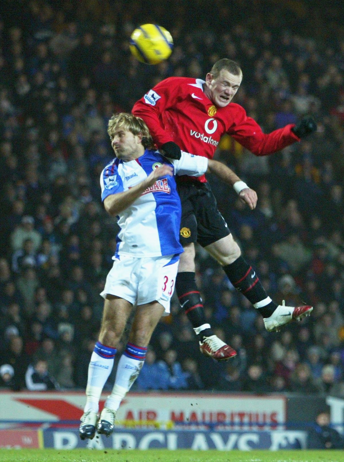 BLACKBURN, ENGLAND - FEBRUARY 1: Wayne Rooney of Manchester and Michael Gray of Blackburn challenge for the ball during the Barclays Premiership match between Blackburn Rovers and Manchester United at Ewood Park on February 1, 2006 in Blackburn, England. (Photo by Matthew Lewis/Getty Images)