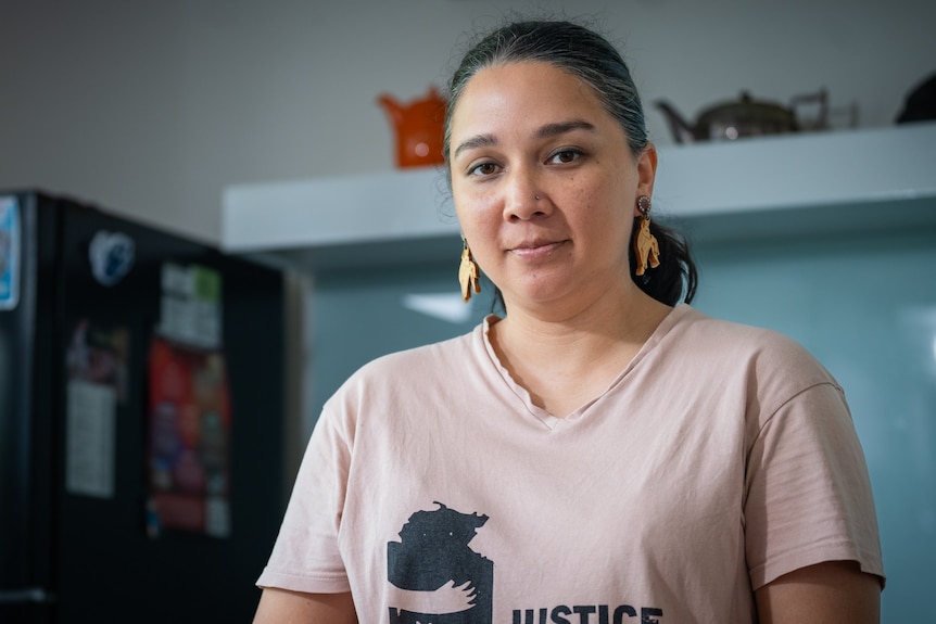 A woman smiles at the camera