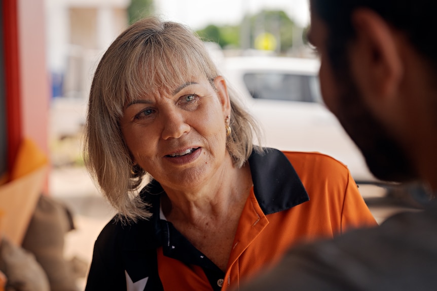 A woman talking to a man.