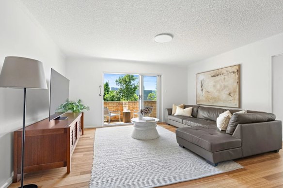 The three-bedroom apartment in the blond brick building was renovated just before going to auction.