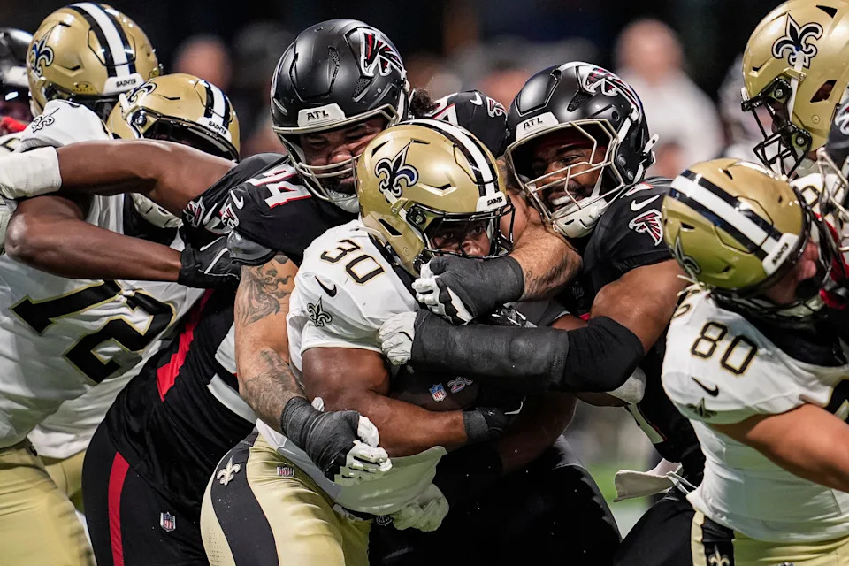 Jan 4, 2026; Atlanta, Georgia, USA; Atlanta Falcons defensive end Lacale London (94) and linebacker Divine Deablo (0) tackle New Orleans Saints running back Audric Estime (30) during the first half at Mercedes-Benz Stadium. Mandatory Credit: Dale Zanine-Imagn Images