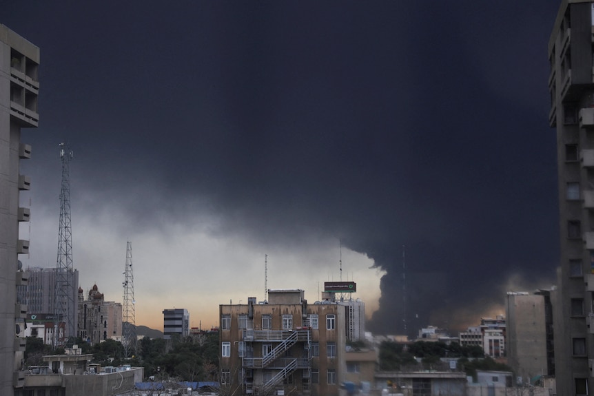 Smoke rises after a reported strike on fuel tanks at an oil refinery