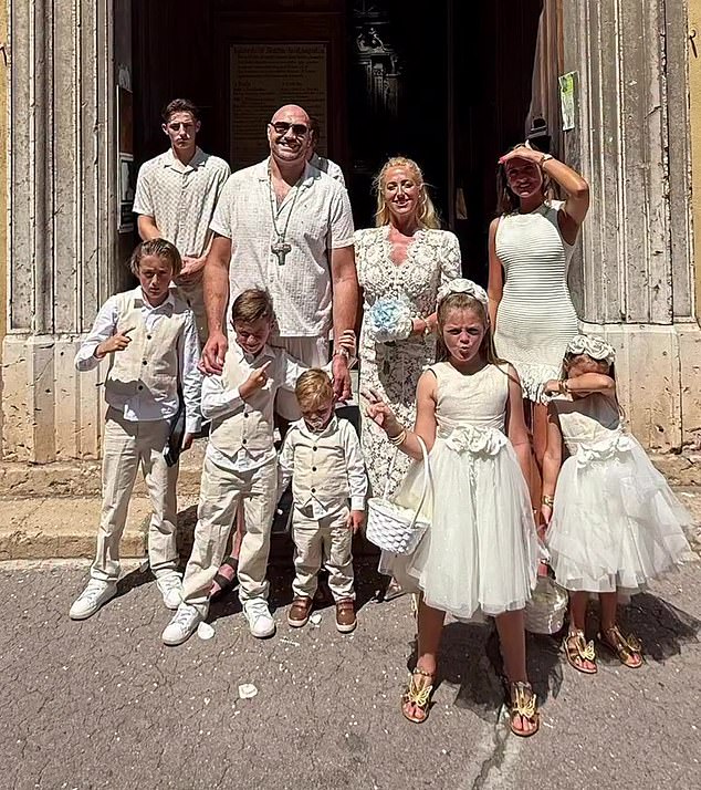 Fury is pictured with wife Paris and their large family. The couple have seven children