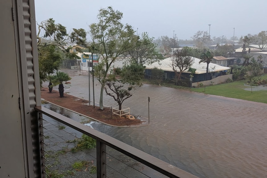 Flooded road with nature strip in middle