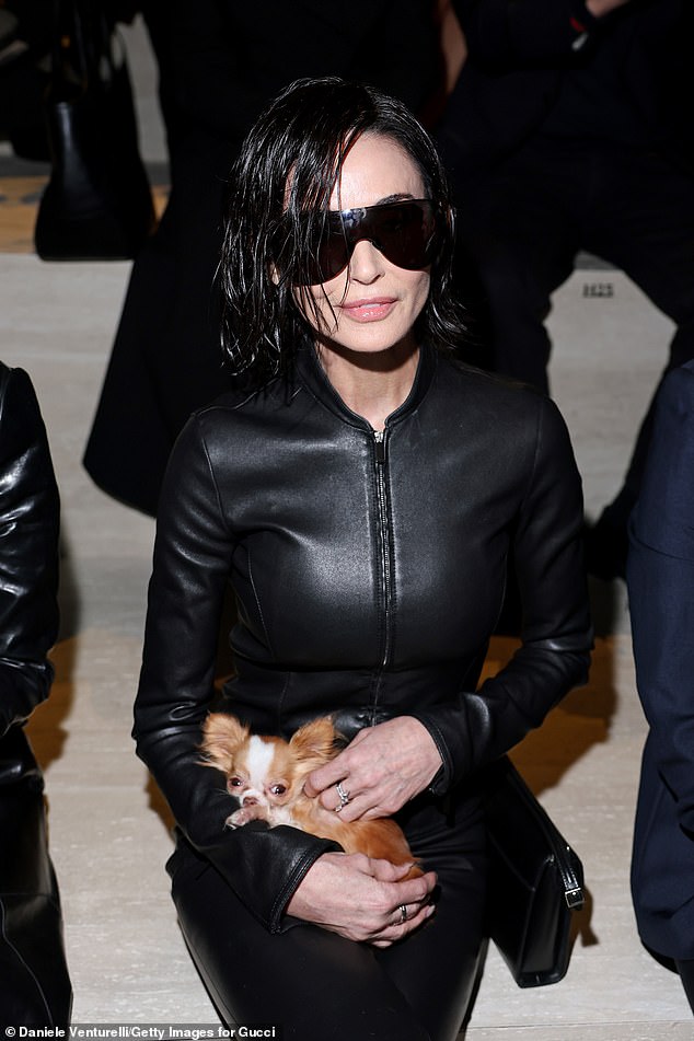 Moore held court front row with her beloved two-year-old Chihuahua Pilaf on her lap during the fashion festivities