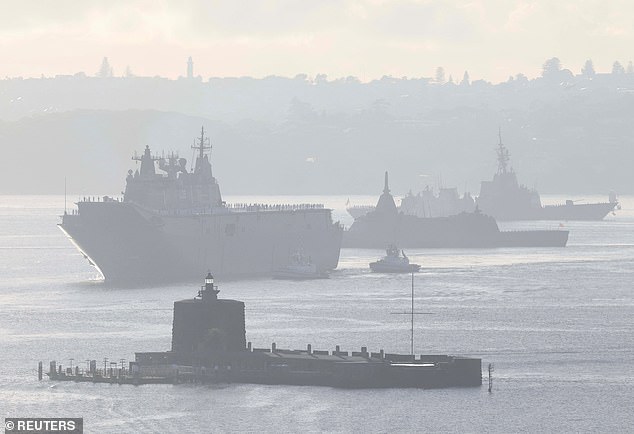 Pictured, HMAS Canberra leads Japan's Kumano and other vessels into Sydney Harbour
