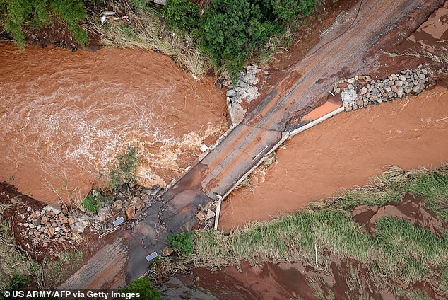 According to the National Weather Service, most of Hawaii will remain under a flood watch through Sunday afternoon. Pictured: a washed out road on Oahu on Saturday