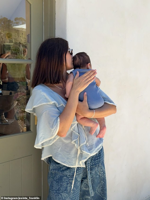 The glamorous model, 34, posted a photo of her tenderly cradling her bub as they relaxed at home. 'Me and my little sidekick, Bam. He's been on every Zoom, attended every meeting, every photoshoot and now, every podcast I've done since he was born,' Jesinta wrote in the caption