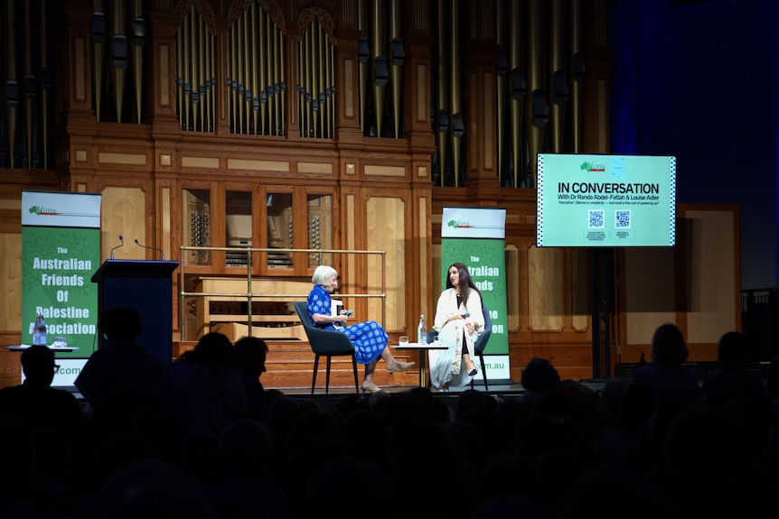 Louise Adler and Randa Abdel-Fattah on stage, a shot taken from a distance.