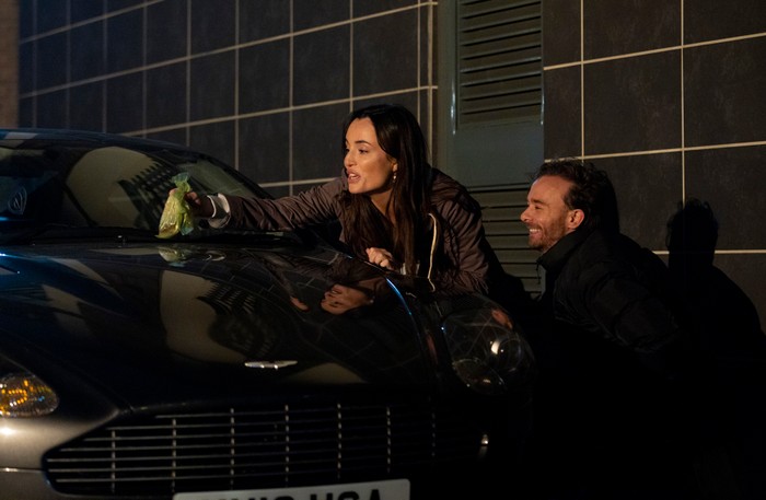 Jodie and David plant a dog poo bag on Adam's car in a scene from Coronation Street