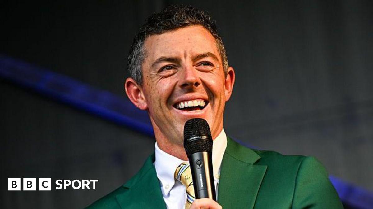 Rory McIlroy smiles during a Q&A session at the Irish Open in 2025, while wearing the green jacket he received after winning The Masters