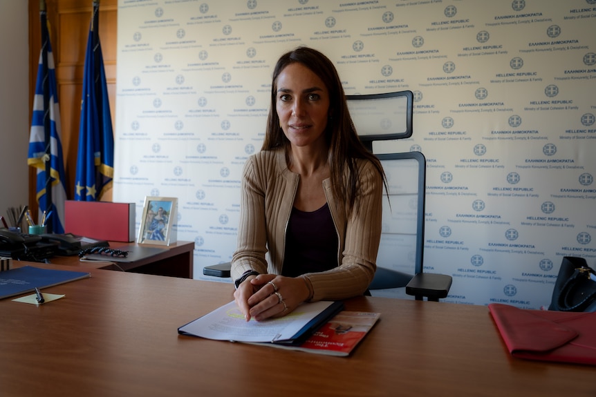 A woman sitting at her desk.