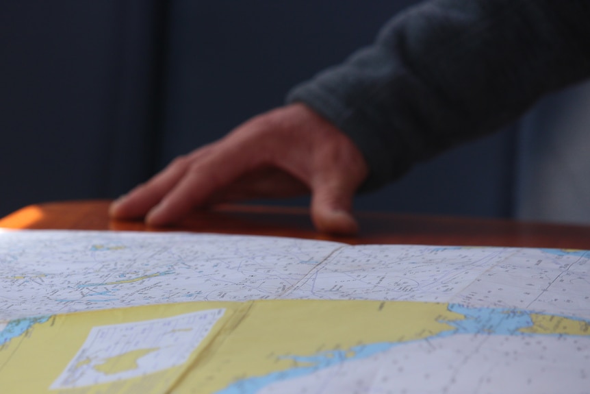 Hands on a map.