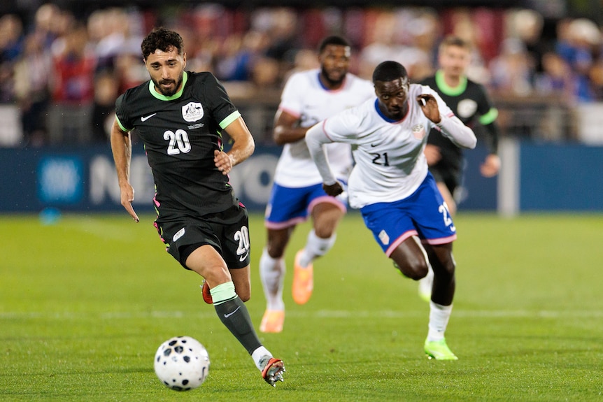 Socceroos player Jacob Italiano runs with the ball during a game.