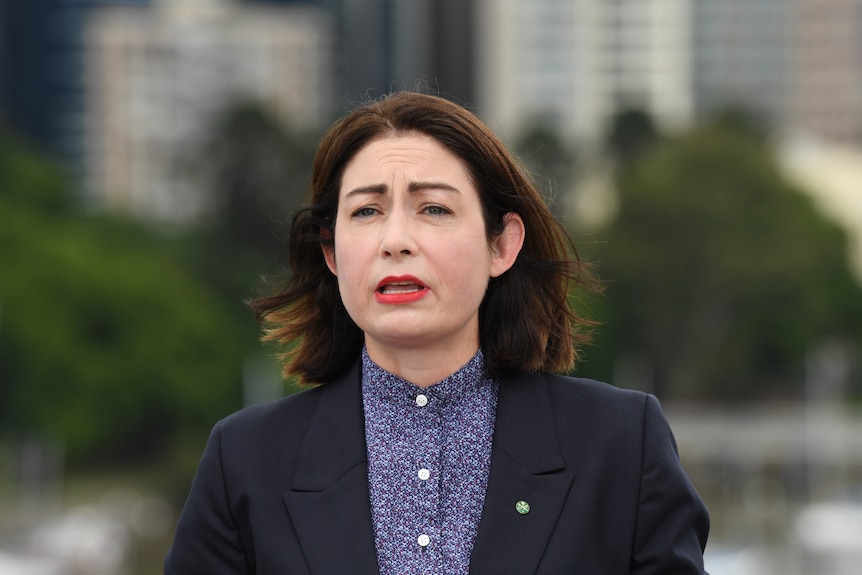 A woman in a black suit.