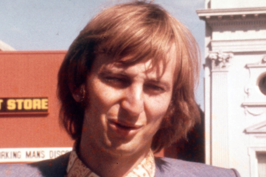 A young man on a city street.