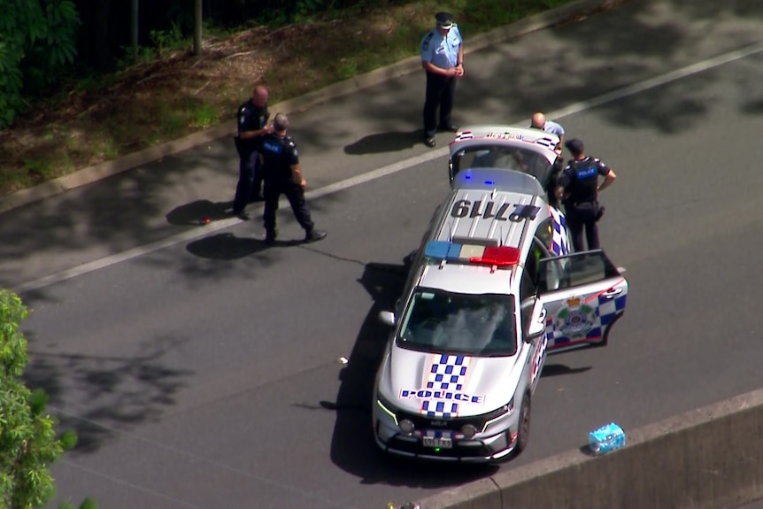 Aerial view of police car with officers nearby