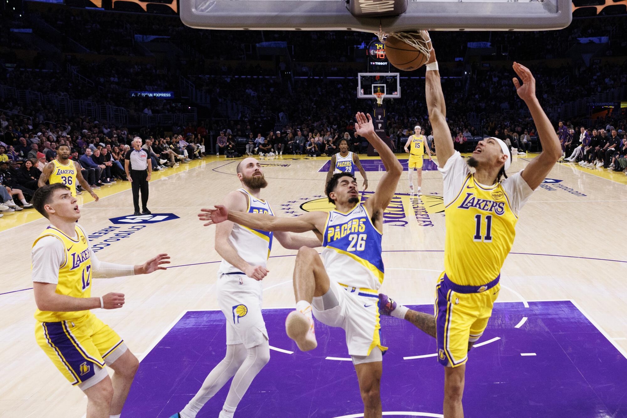 Lakers center Jaxson Hayes scores at the rim in front of Indiana Pacers guard Ben Sheppard Friday at Crypto.com Arena.