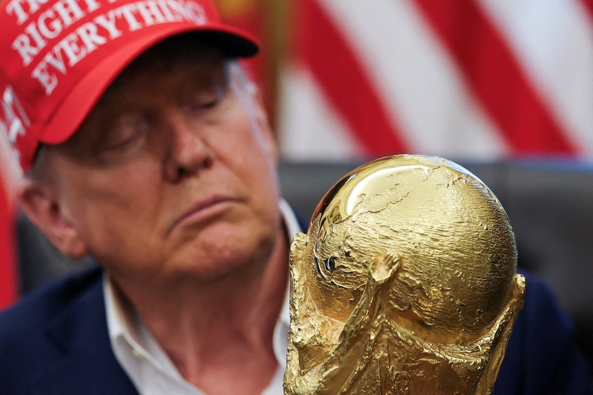 US President Donald Trump holds the FIFA World Cup Trophy