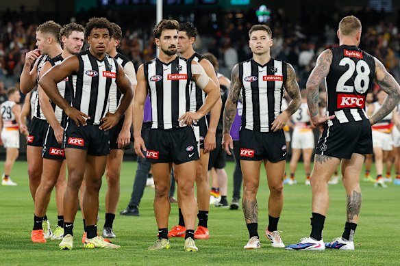 The Magpies look dejected after a rare MCG loss.