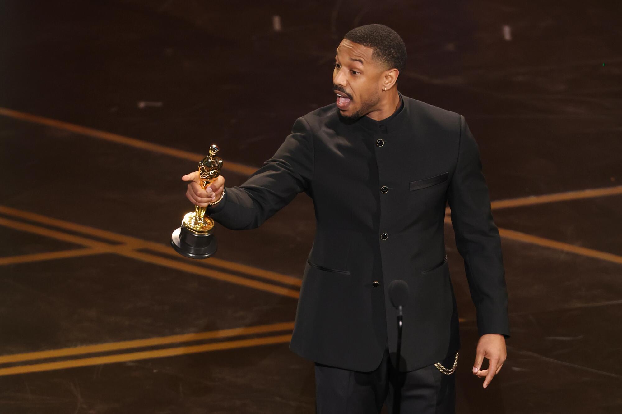 Michael B. Jordan accepts the Oscar for lead actor for "Sinners" during the 98th Academy Awards.