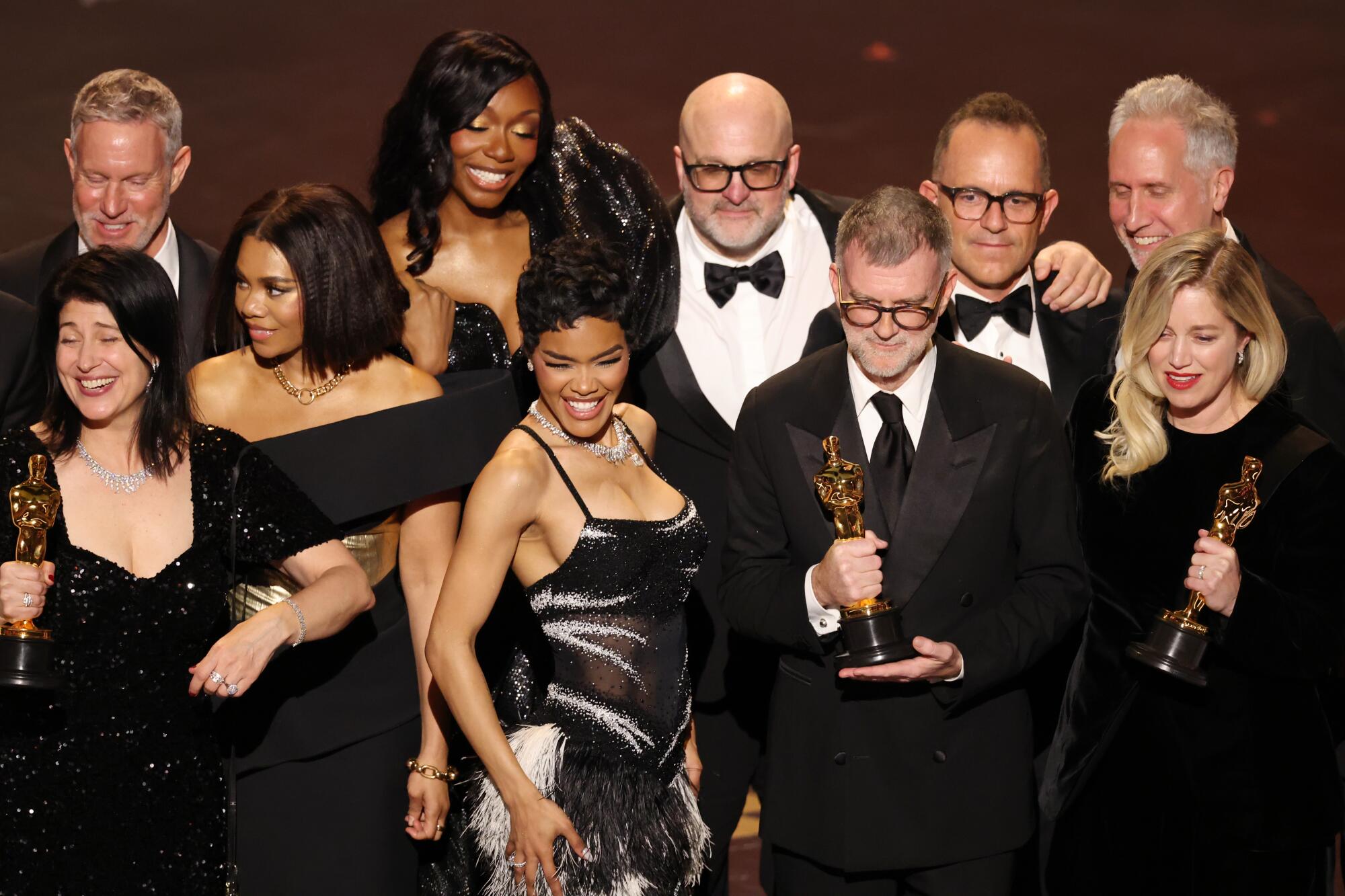 Paul Thomas Anderson, second from right, and Sara Murphy accept the Oscar for best picture for "One Battle After Another."